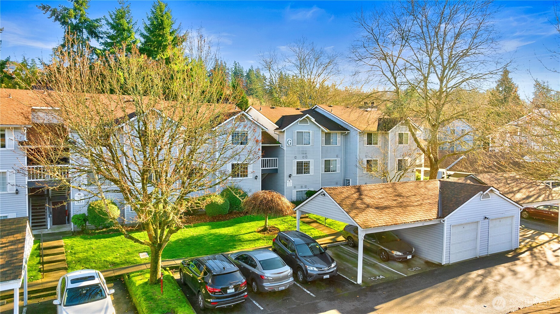 7453 Newcastle Golf Club Road, Unit G103 Newcastle, WA 98059 - Photo 30 of 37 a view of a patio with table and chairs and potted plants