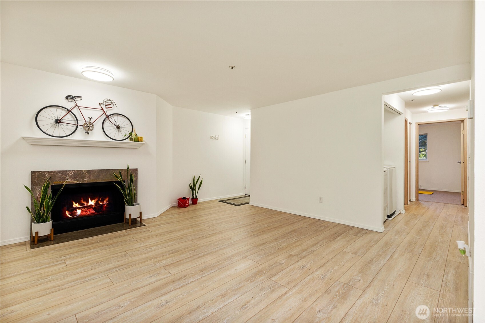 7453 Newcastle Golf Club Road, Unit G103 Newcastle, WA 98059 - Photo 4 of 37 a view of a livingroom with a fireplace and wooden floor