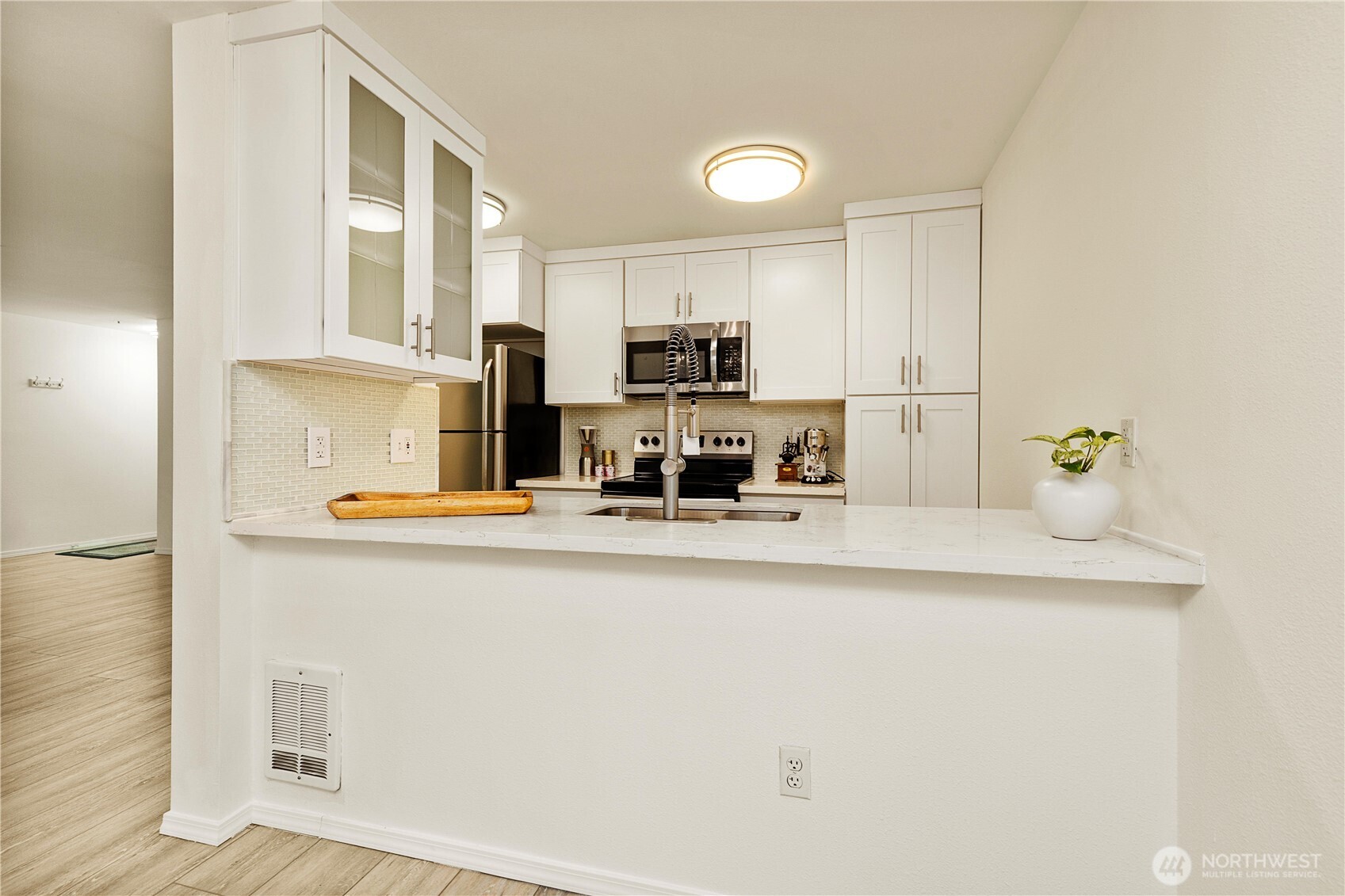 7453 Newcastle Golf Club Road, Unit G103 Newcastle, WA 98059 - Photo 9 of 37 a kitchen with kitchen island a sink a stove and a refrigerator
