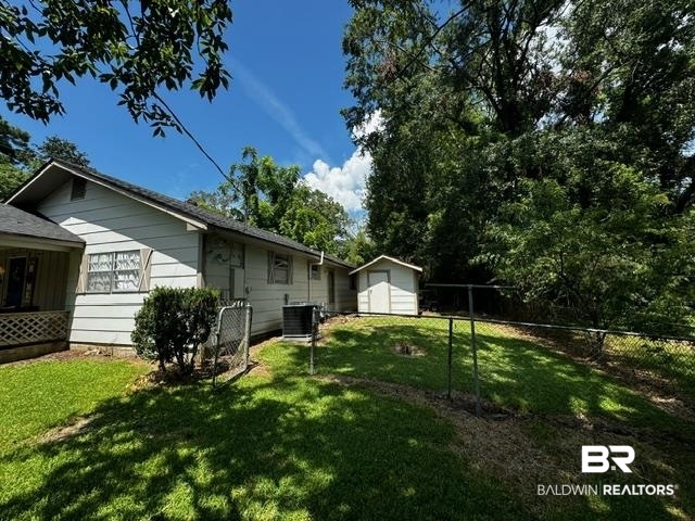 502 Forest Street Mobile, AL 36611 - Photo 10 of 10 View of yard with central AC and a storage unit