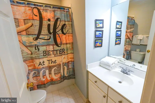 a view of a hallway with wooden floor and closet