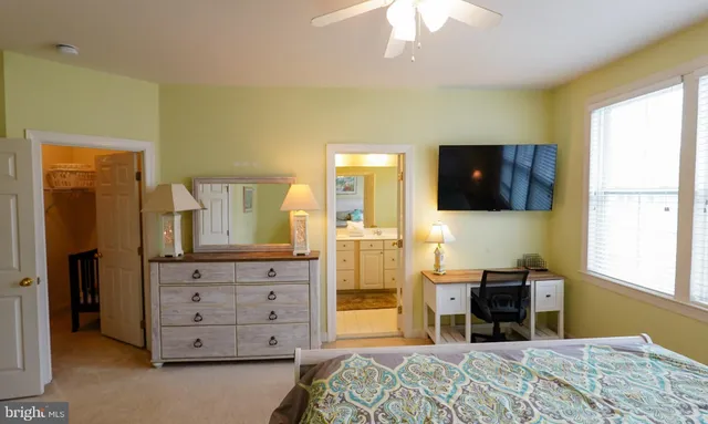 a bed sitting in a bedroom next to a window