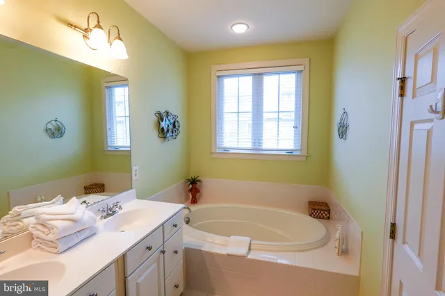 a white toilet sitting next to a white wall