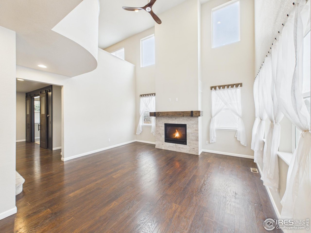 420 South 5th Street Berthoud, CO 80513 - Photo 15 of 47 a view of a livingroom with wooden floor and a ceiling fan