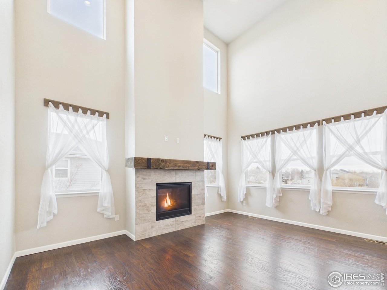 420 South 5th Street Berthoud, CO 80513 - Photo 18 of 47 a view of an empty room with wooden floor and a window
