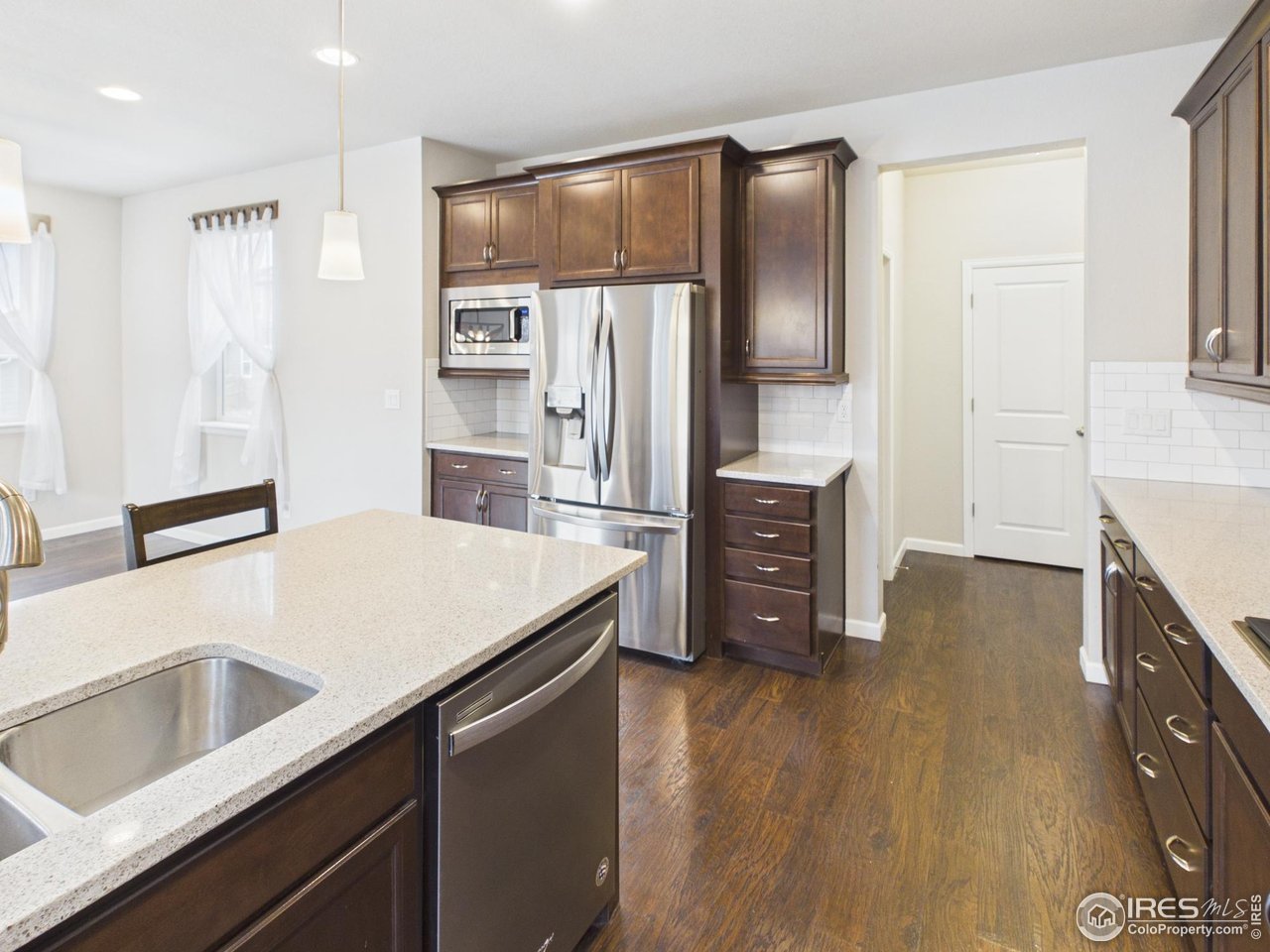 420 South 5th Street Berthoud, CO 80513 - Photo 6 of 47 a kitchen with stainless steel appliances a refrigerator and a stove