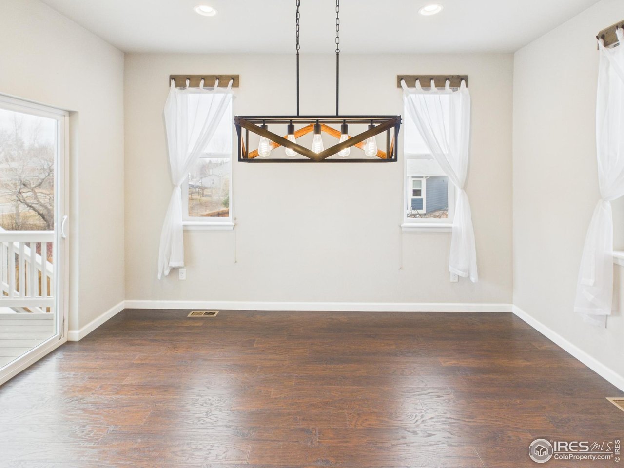 420 South 5th Street Berthoud, CO 80513 - Photo 10 of 47 a view of a kitchen with wooden floor and a window