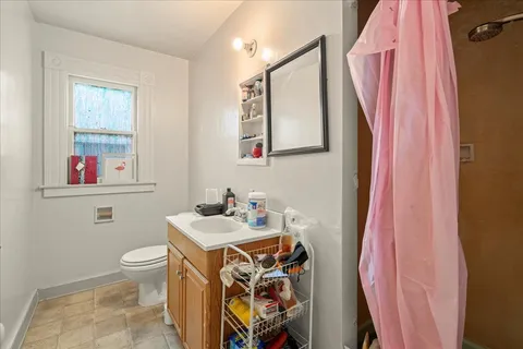 a bathroom with a sink toilet and a mirror