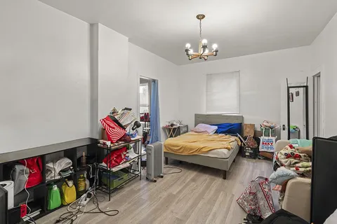 a bed room with furniture and a chandelier