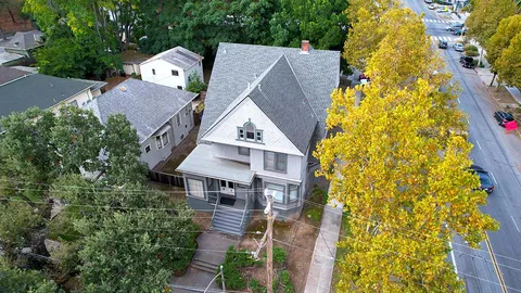 an aerial view of a house with swimming pool and garden space