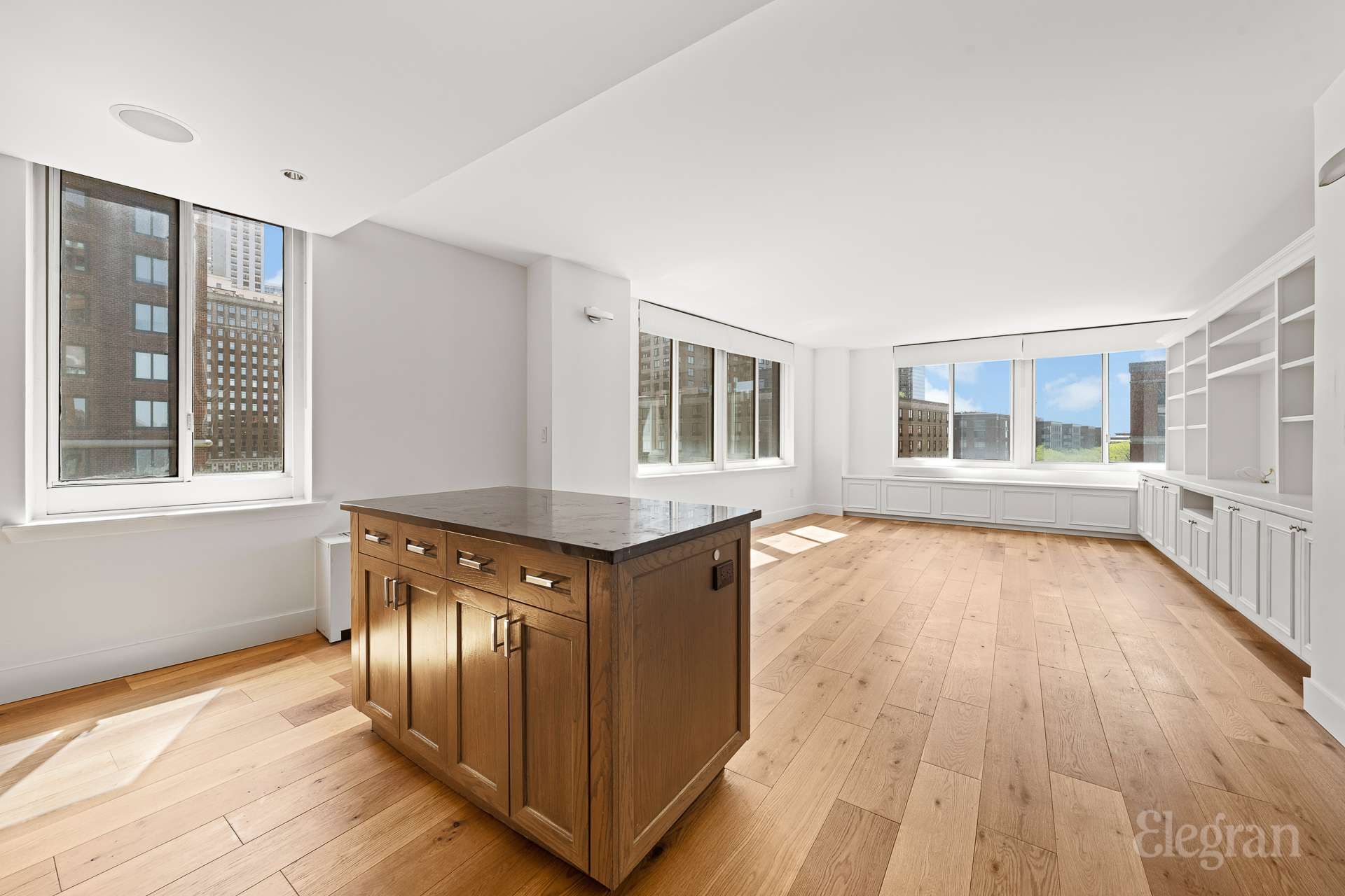 333 Rector Place, Unit 805 Manhattan, NY 10280 - Photo 11 of 28 a view of an empty room with wooden floor and a window