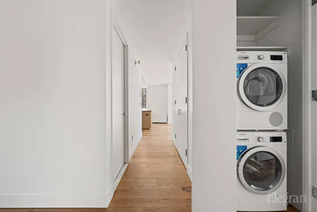 a view of a hallway with washer and dryer