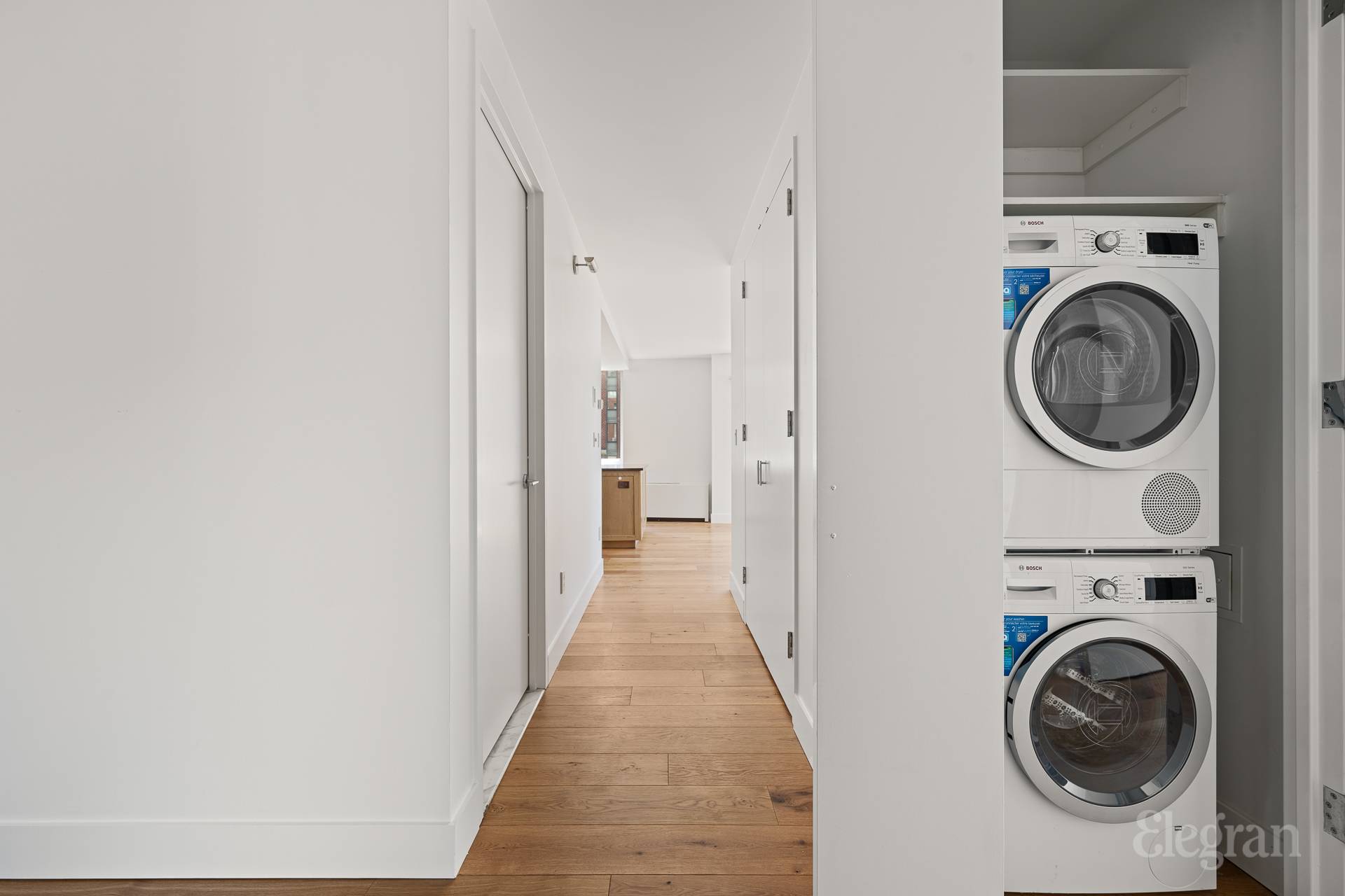 333 Rector Place, Unit 805 Manhattan, NY 10280 - Photo 14 of 28 a view of a hallway with washer and dryer