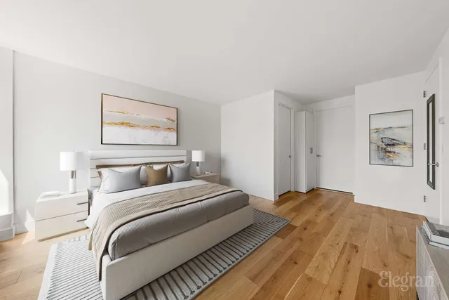 a bedroom with a bed and a painting on the wall