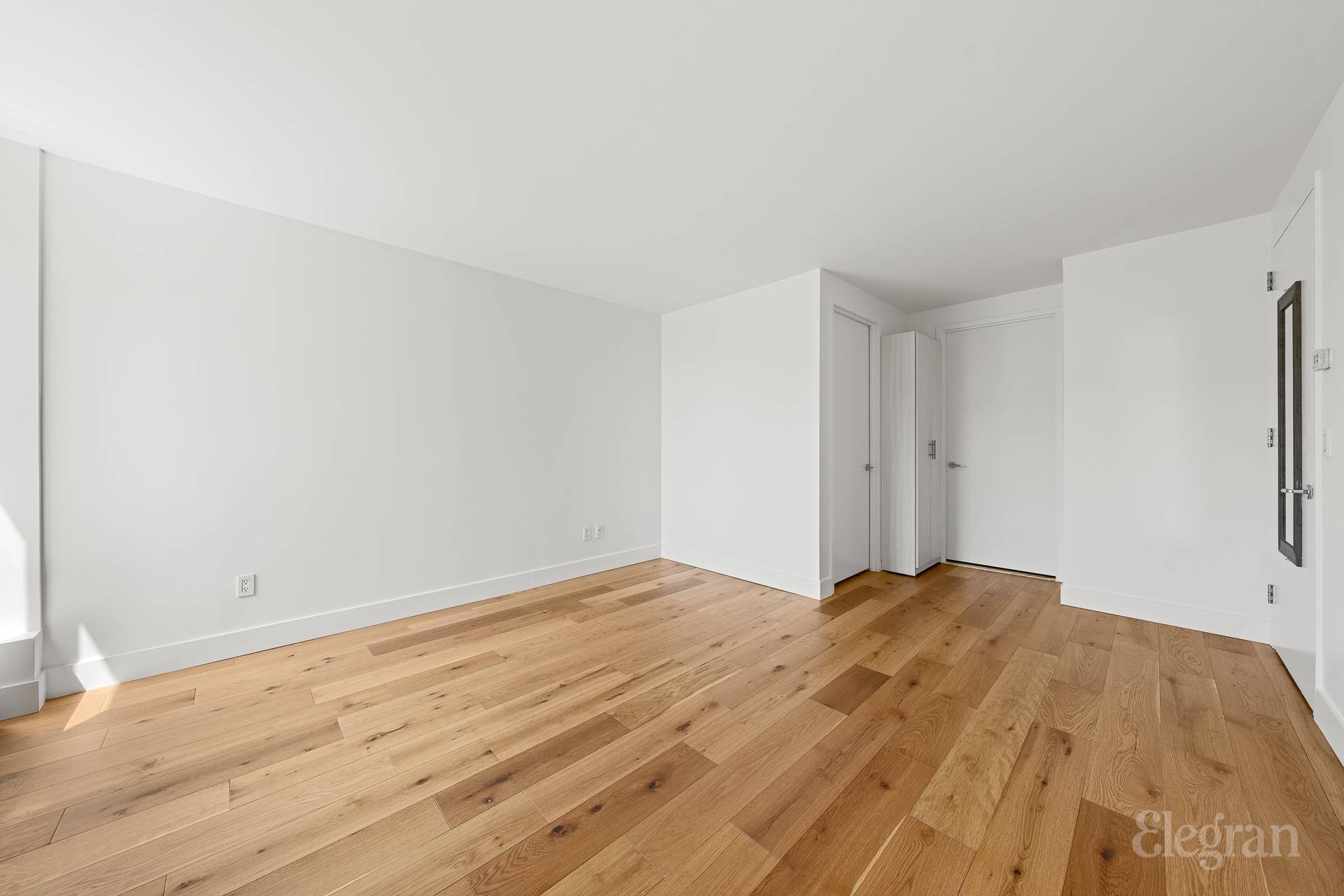 333 Rector Place, Unit 805 Manhattan, NY 10280 - Photo 16 of 28 a view of empty room with wooden floor