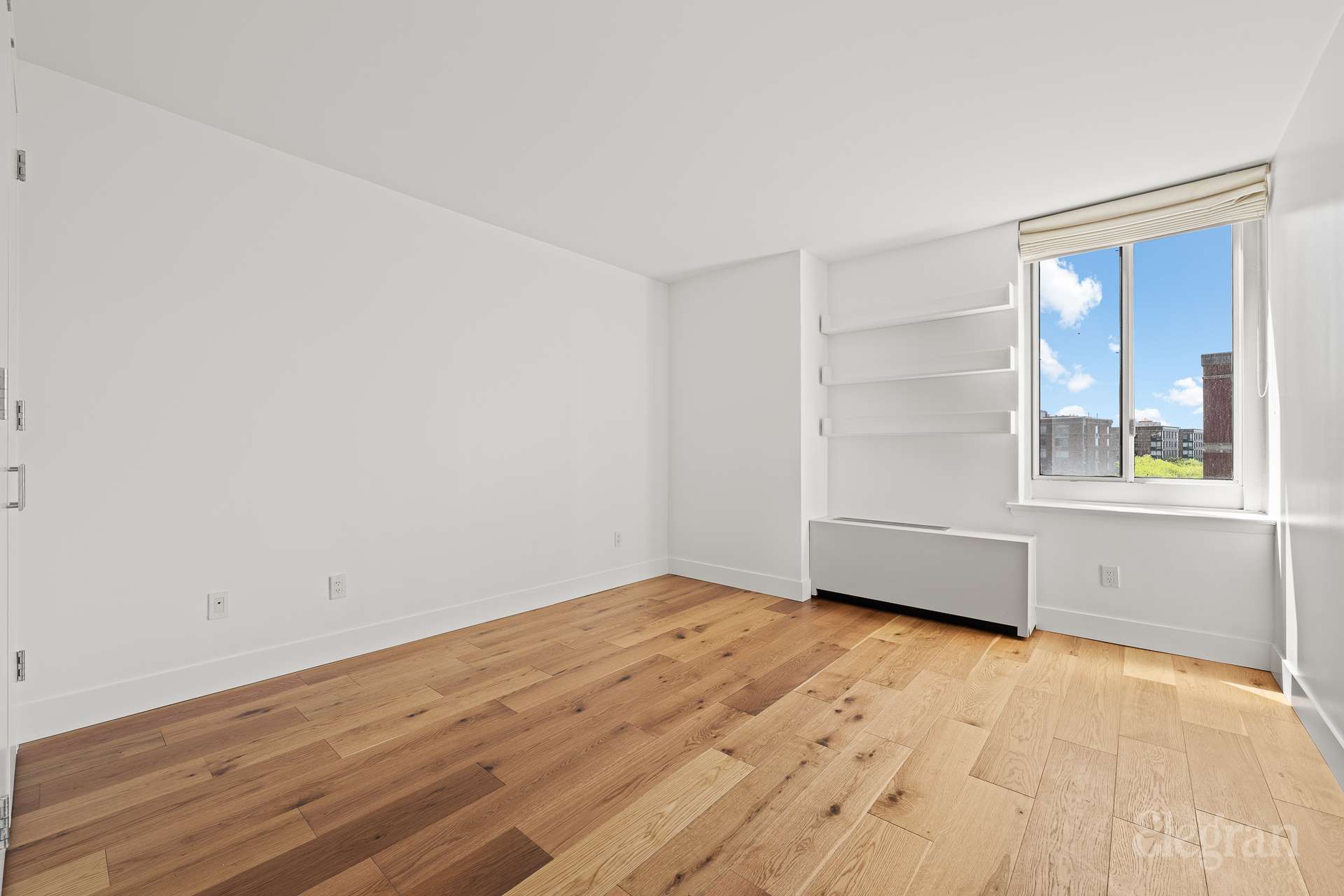 333 Rector Place, Unit 805 Manhattan, NY 10280 - Photo 17 of 28 a view of an empty room with wooden floor and a window