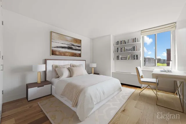 a bedroom with a large bed couch and a window