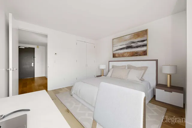 a bedroom with a bed and a painting on the wall