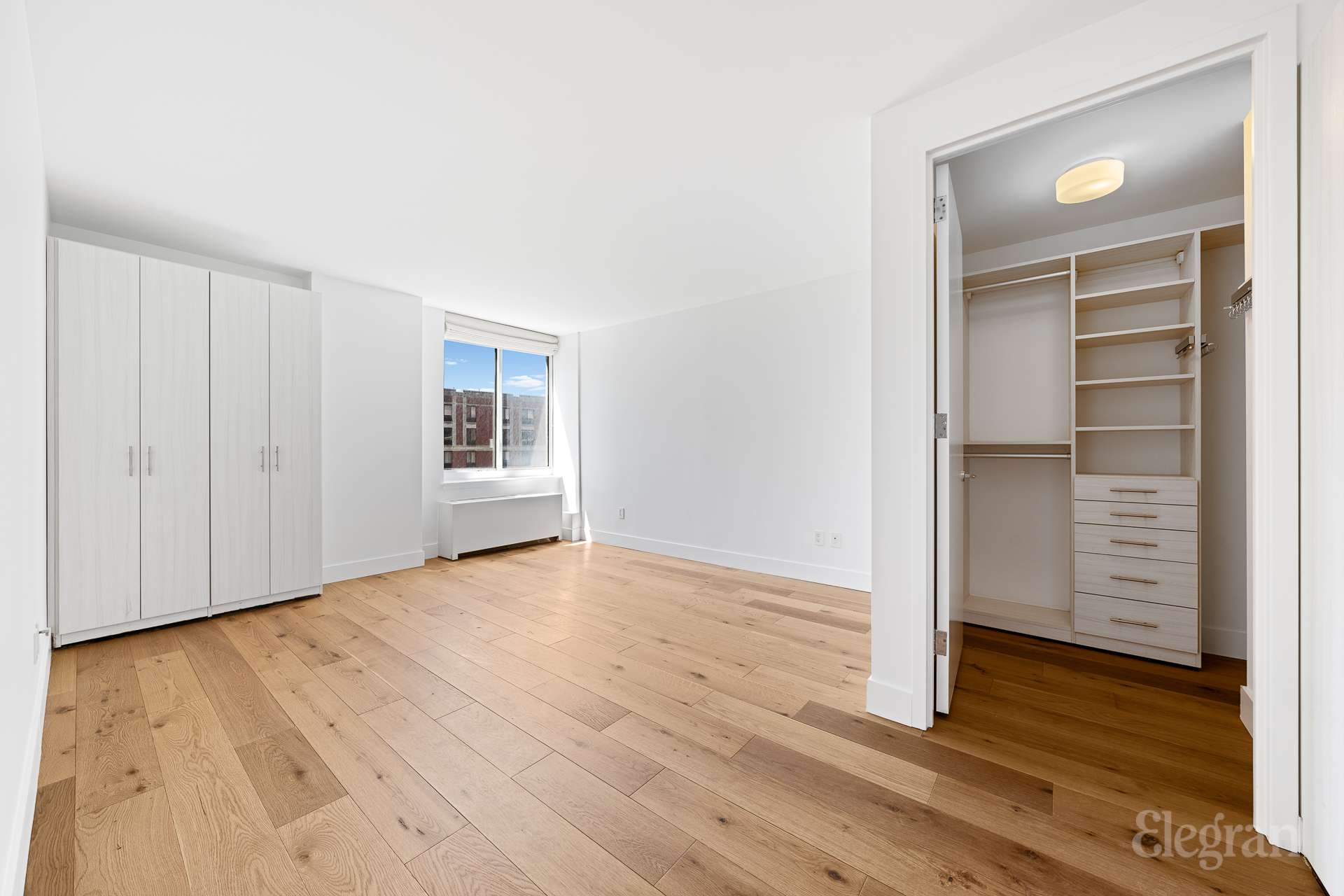 333 Rector Place, Unit 805 Manhattan, NY 10280 - Photo 23 of 28 an empty room with wooden floor and closet