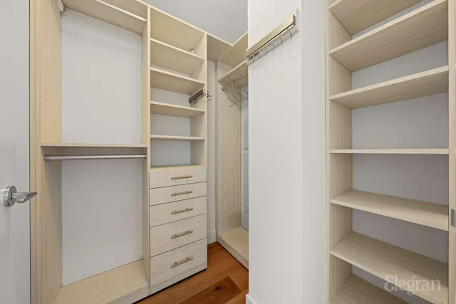 a view of walk in closet with empty racks