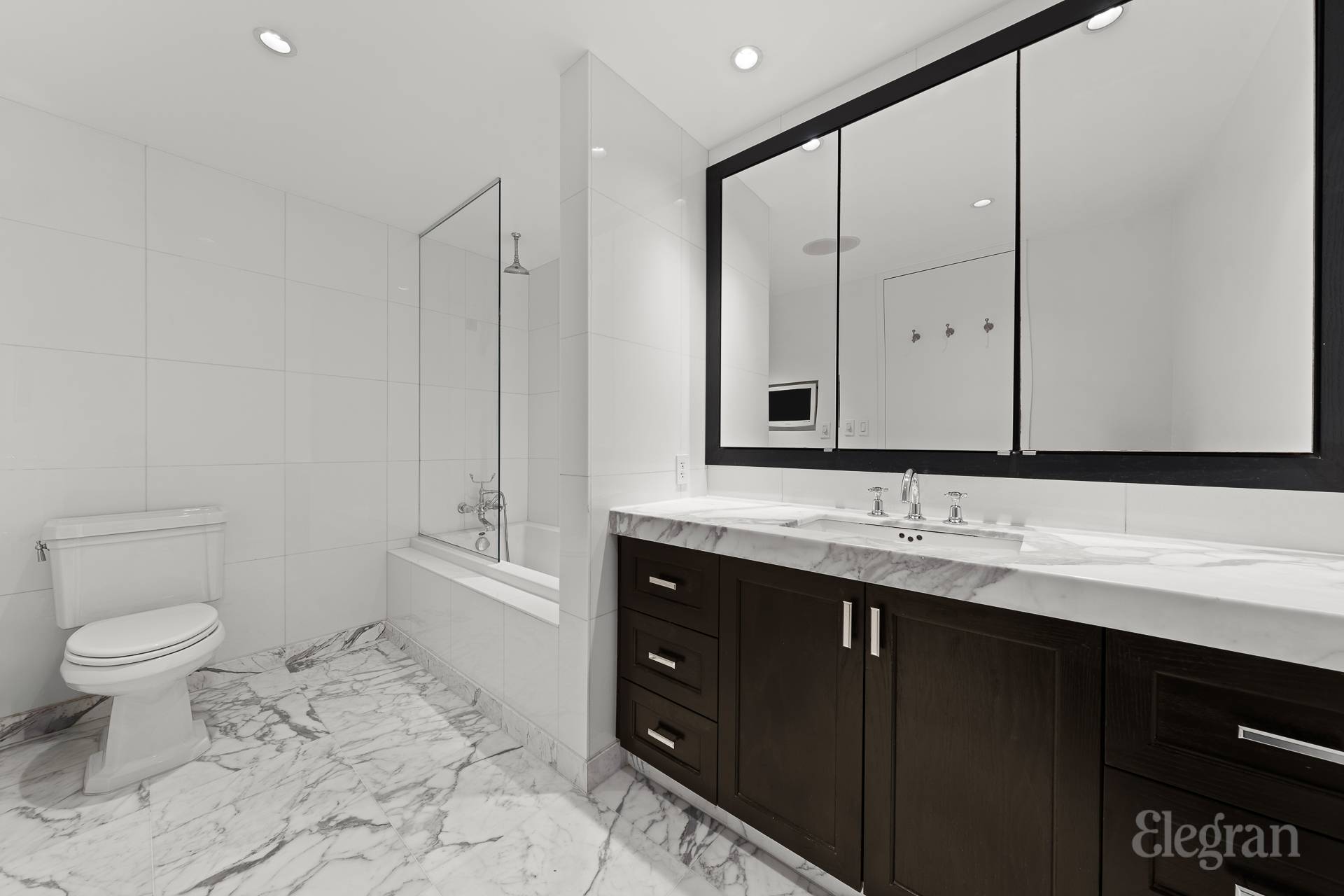 333 Rector Place, Unit 805 Manhattan, NY 10280 - Photo 25 of 28 a bathroom with a toilet sink and mirror