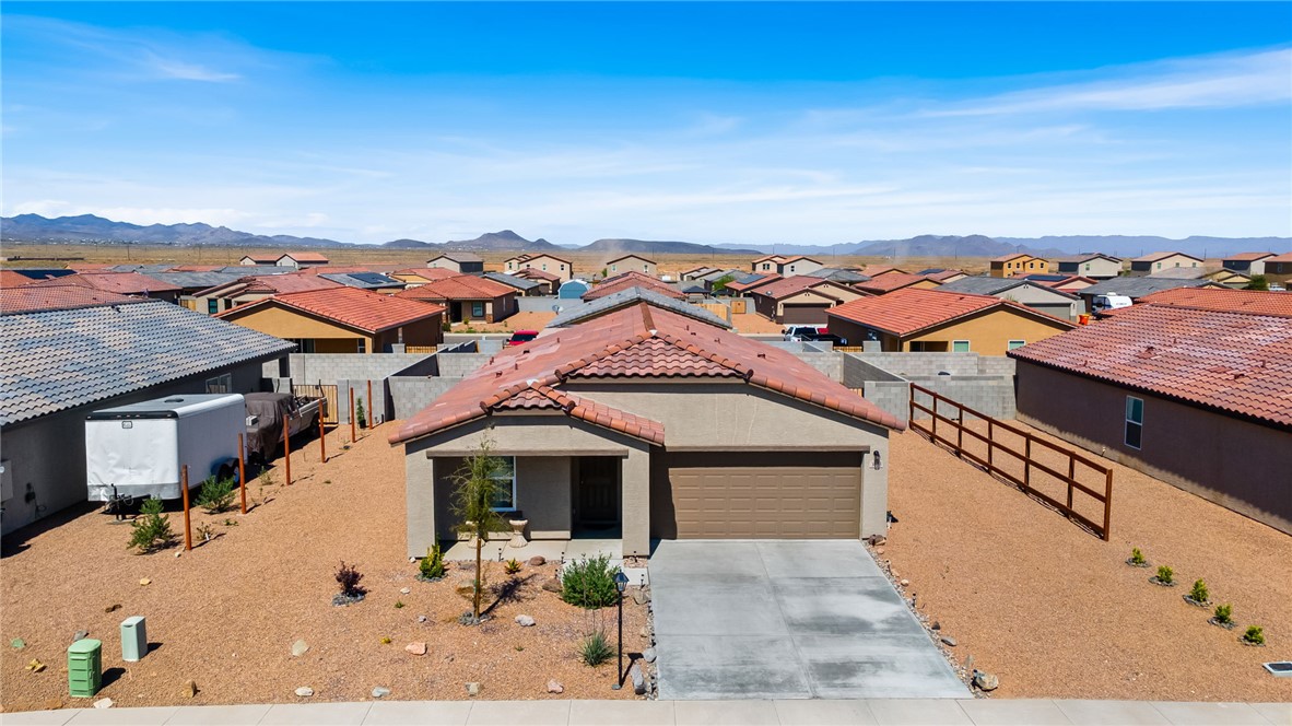 3623 East Andrea Drive Kingman, AZ 86409 - Photo 1 of 40 This property features a stucco exterior with a tiled roof, an attached garage, and a concrete driveway