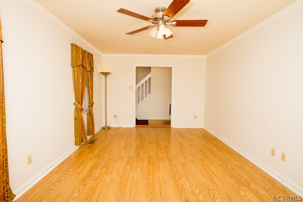 10422 White Rabbit Road North Chesterfield, VA 23235 - Photo 8 of 23 a view of a big room with wooden floor and a ceiling fan