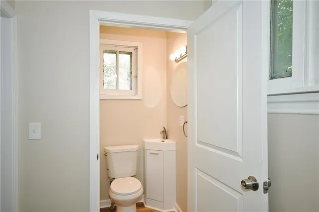 a white toilet sitting next to a bathroom sink