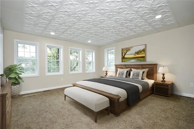 a spacious bedroom with a large bed and a potted plant