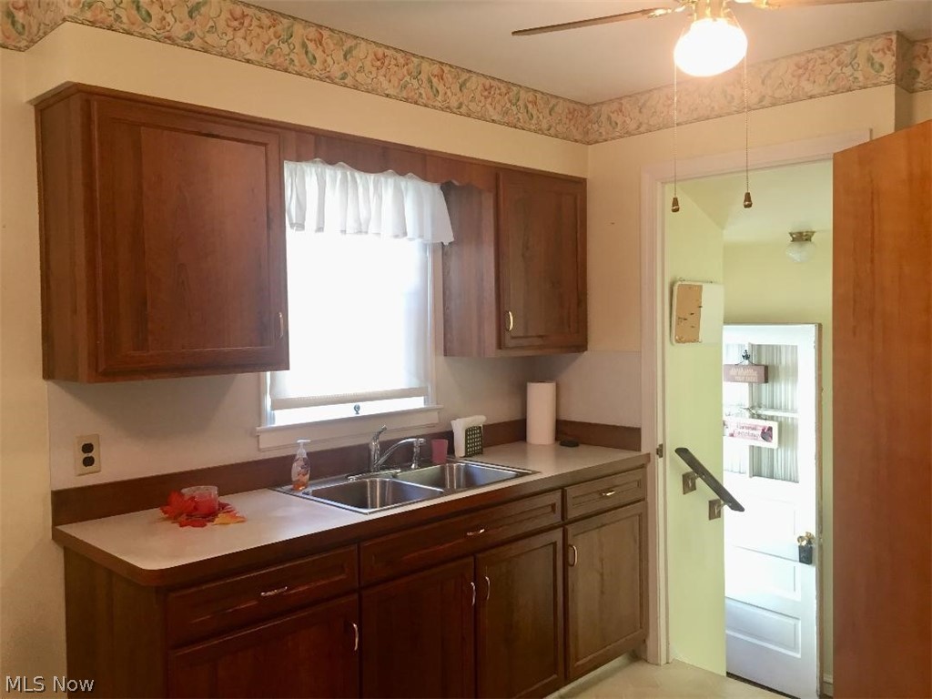 13812 Granger Road Cleveland, OH 44125 - Photo 2 of 29 Fresh and inviting with updated cabinetry and sink and lighted ceiling fan.