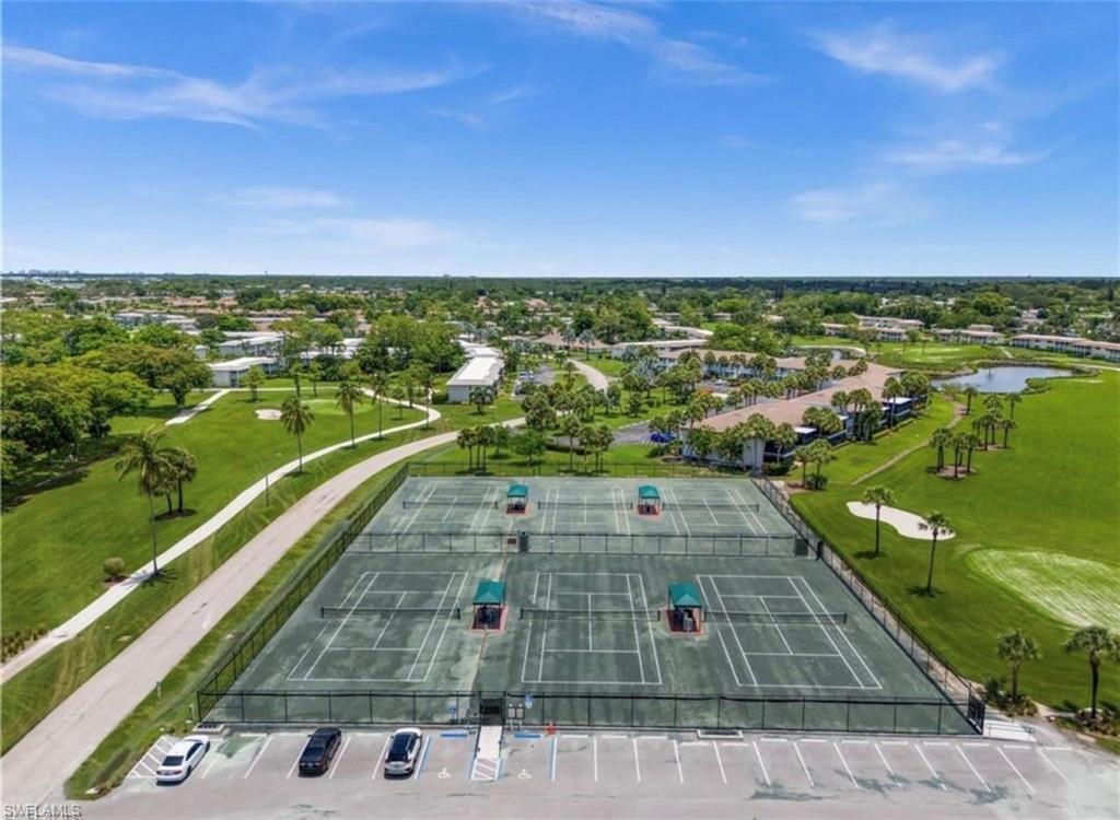 198 Albi Road, Unit 604 Naples, FL 34112 - Photo 38 of 38 Bird's eye view of a golf club and a nearby body of water