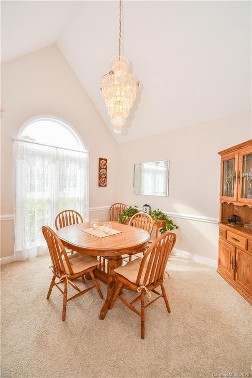 3400 Helms Pond Road Monroe, NC 28110 - Photo 11 of 24 a dining room with furniture a chandelier and window
