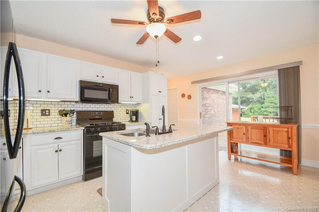 3400 Helms Pond Road Monroe, NC 28110 - Photo 14 of 24 a kitchen that has a sink a stove and a refrigerator