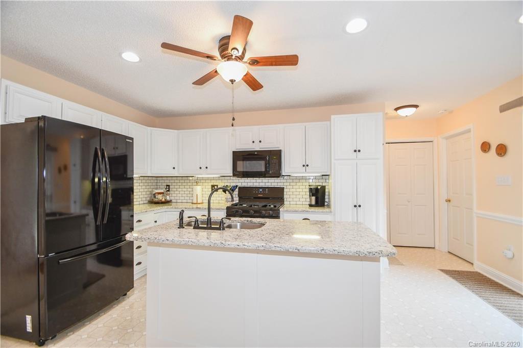 3400 Helms Pond Road Monroe, NC 28110 - Photo 16 of 24 a kitchen with stainless steel appliances granite countertop a refrigerator a stove a microwave oven a sink with island and cabinets