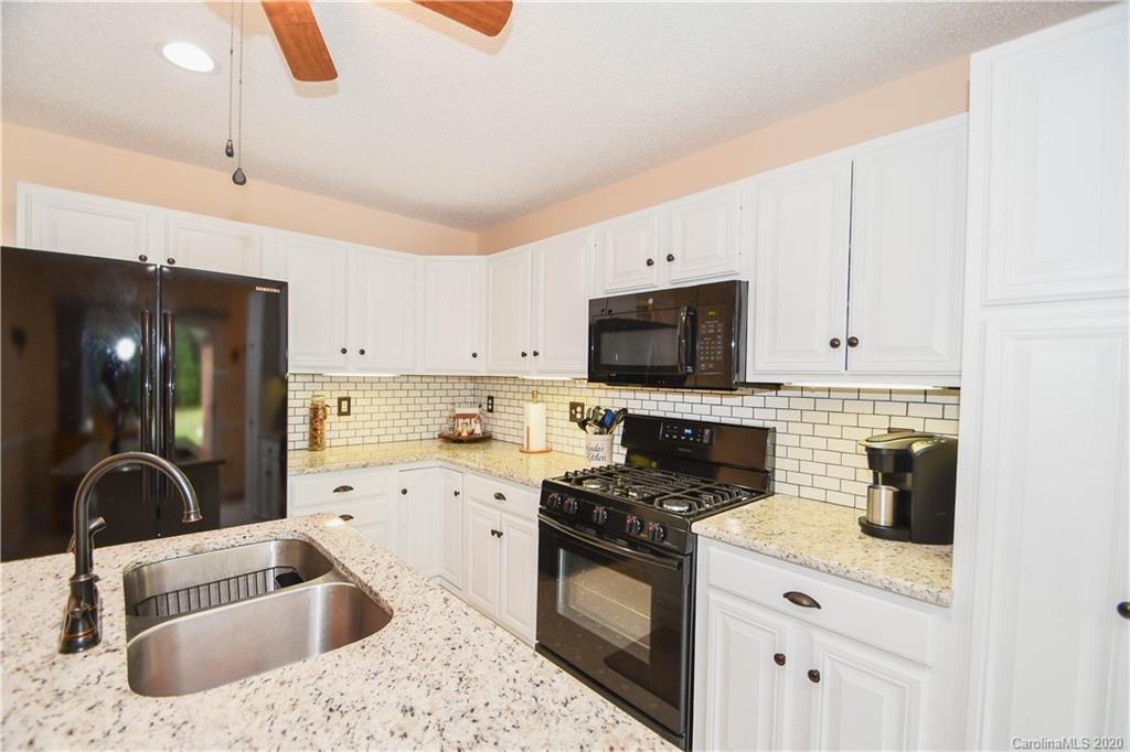 3400 Helms Pond Road Monroe, NC 28110 - Photo 17 of 24 a kitchen with a sink a stove and cabinets