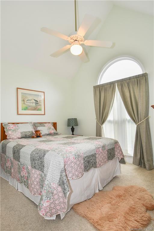 3400 Helms Pond Road Monroe, NC 28110 - Photo 20 of 24 a bedroom with a large bed and a chandelier