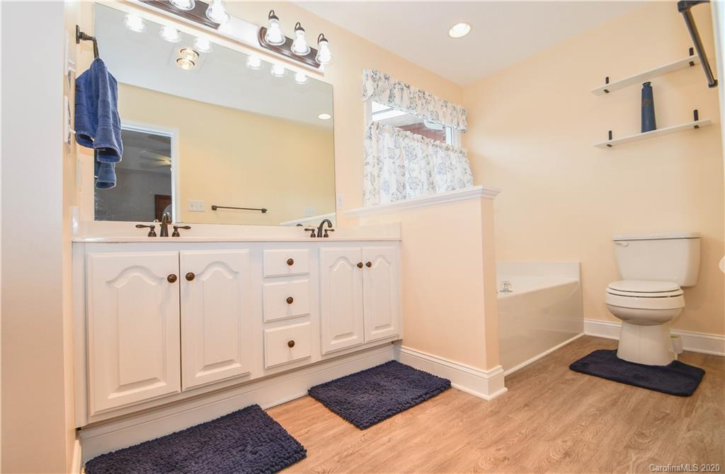 3400 Helms Pond Road Monroe, NC 28110 - Photo 22 of 24 a bathroom with a sink a toilet and mirror