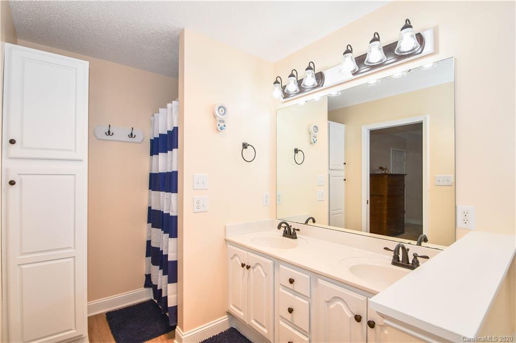 3400 Helms Pond Road Monroe, NC 28110 - Photo 23 of 24 a bathroom with a double vanity sink mirror and shower