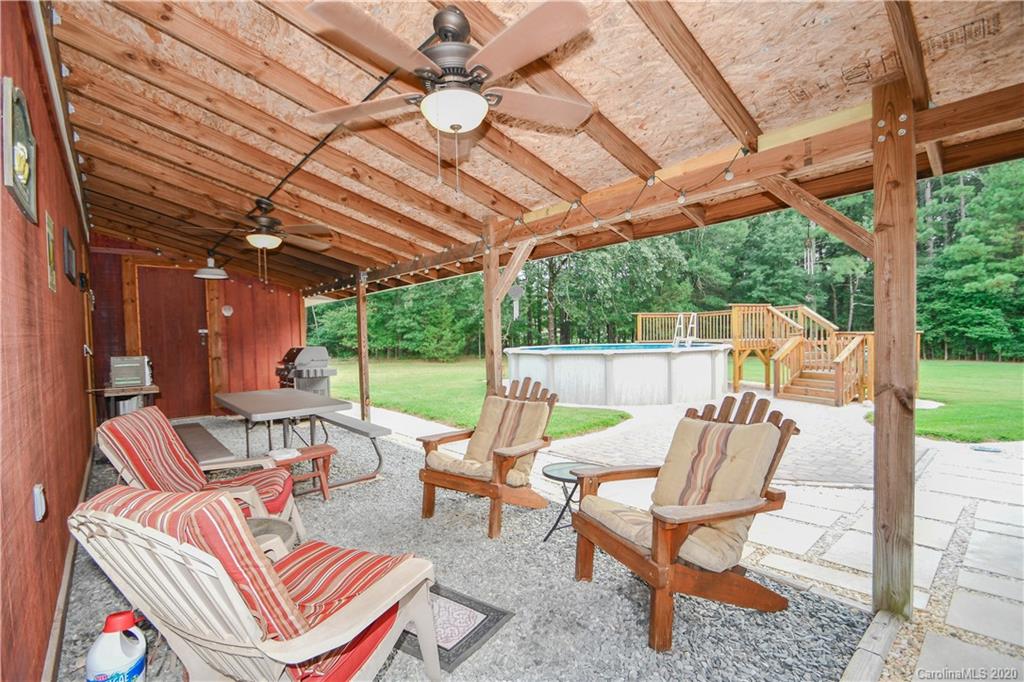 3400 Helms Pond Road Monroe, NC 28110 - Photo 5 of 24 a view of a patio with table and chairs and floor to ceiling window with wooden floor