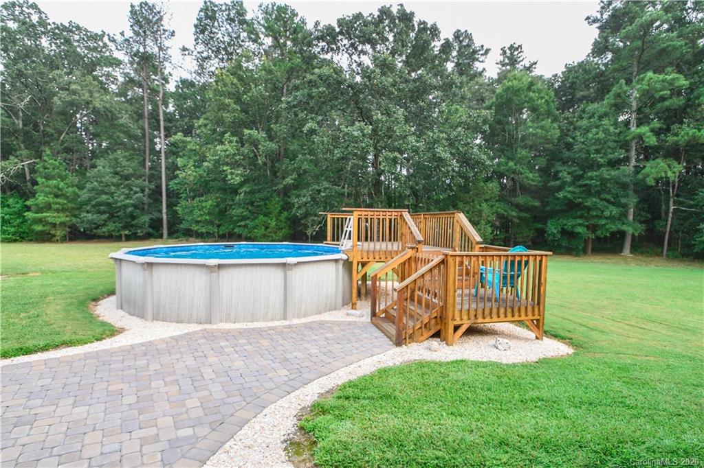3400 Helms Pond Road Monroe, NC 28110 - Photo 8 of 24 a view of a deck with a chair and a small yard