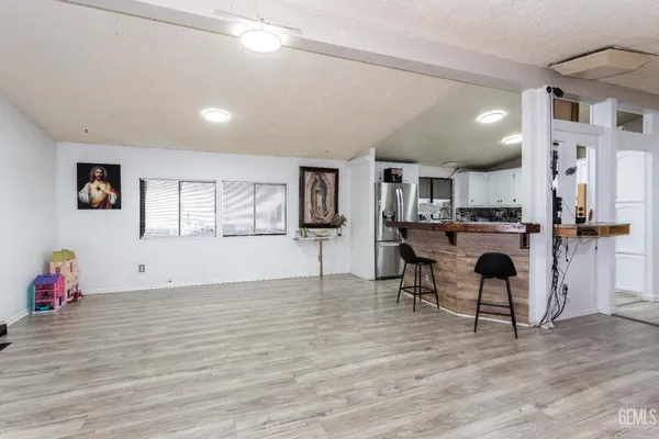 a kitchen with stainless steel appliances kitchen island granite countertop a refrigerator and a stove top oven