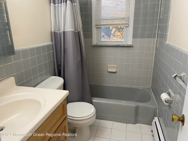 a bathroom with a toilet and a bathtub