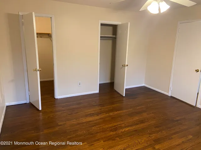 an empty room with wooden floor and door