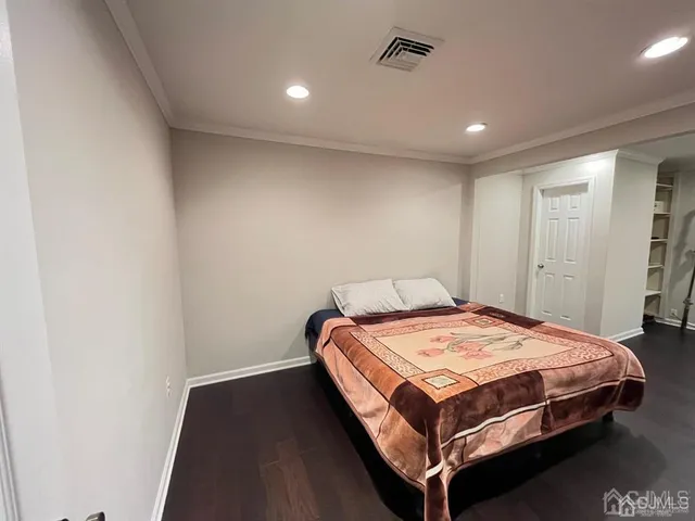 a bed sitting in a spacious bedroom next to a window