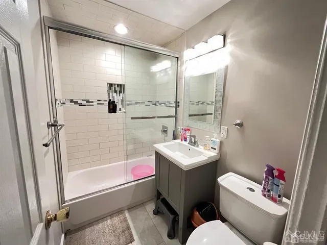 a bathroom with a sink mirror toilet and bathtub