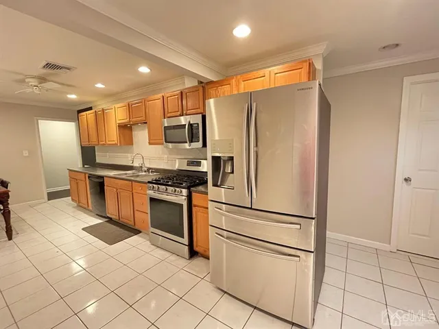 a kitchen with stainless steel appliances granite countertop a refrigerator and a sink
