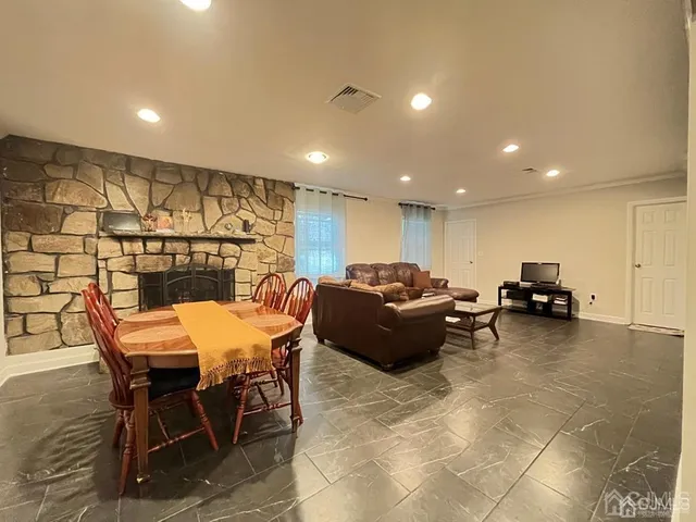 a living room with furniture a flat screen tv and a table