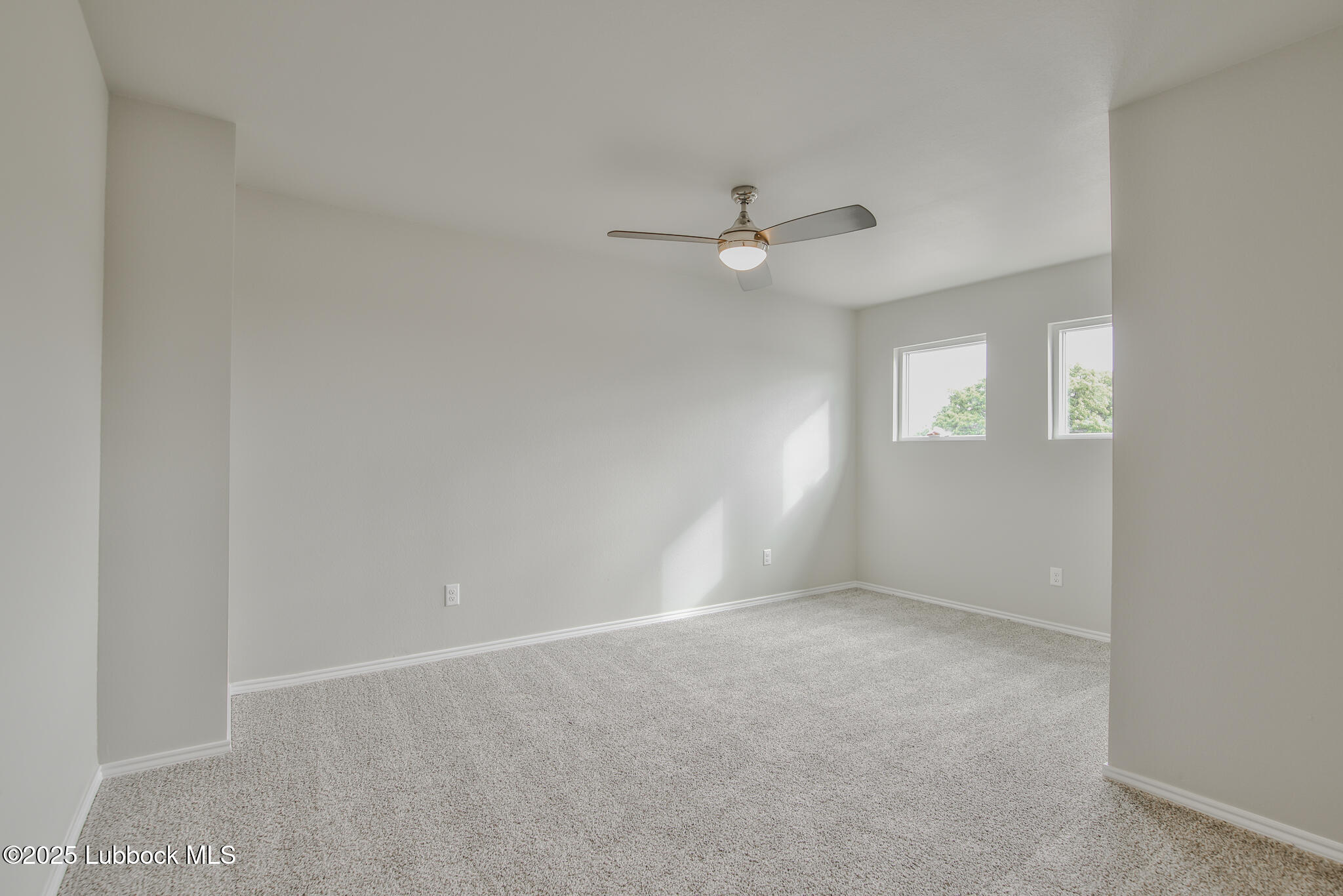 3117 74th Street Lubbock, TX 79423 - Photo 27 of 36 an empty room with windows and fan