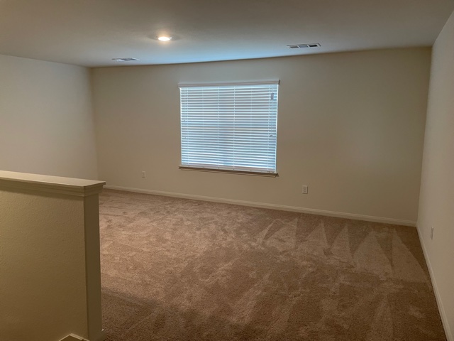 18741 Speculator Lane Elgin, TX 78621 - Photo 18 of 28 Unfurnished room with light colored carpet and baseboards
