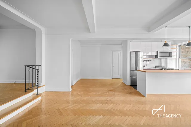 a kitchen with stainless steel appliances a white cabinets and a window